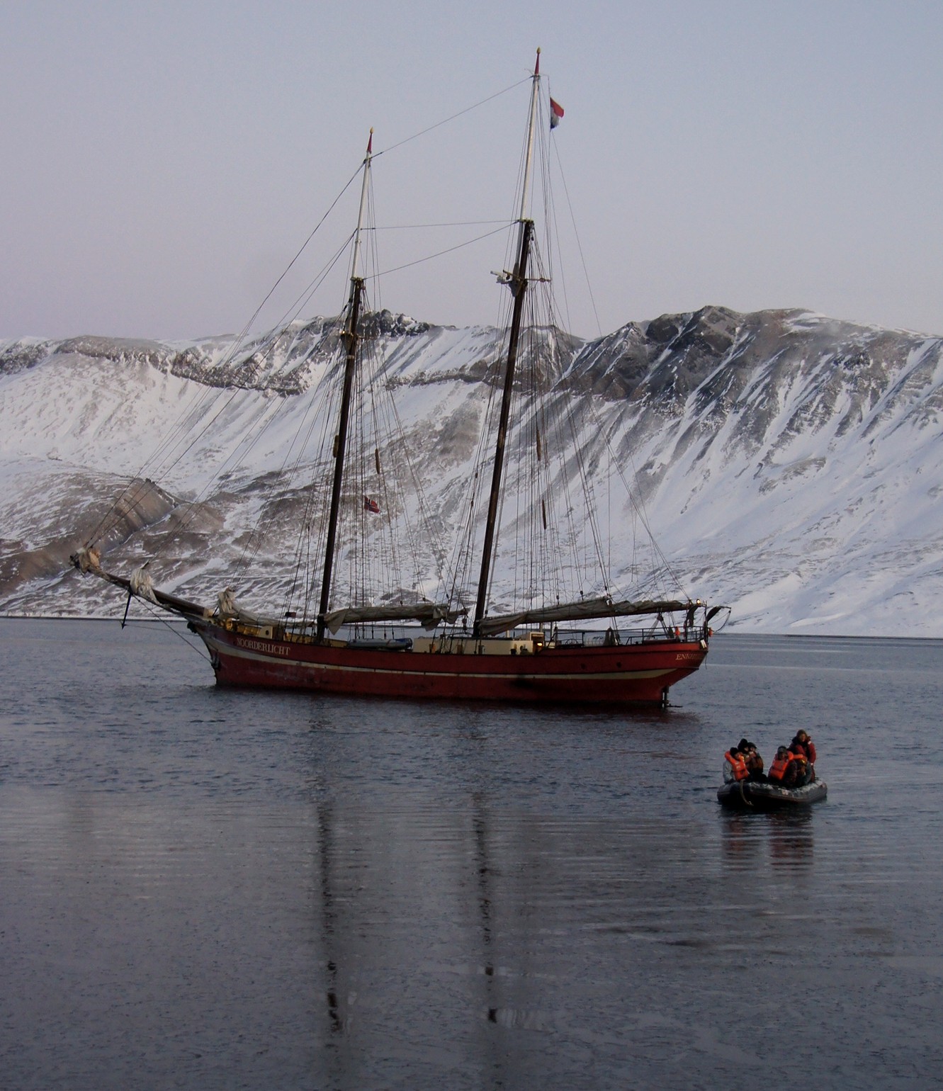 Ship and dinghy with people